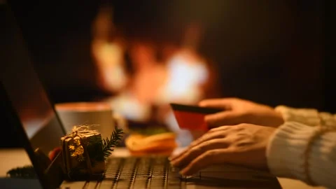 A woman is browsing an online store looking for Christmas gifts from home. Sa Stock Footage 162806180
