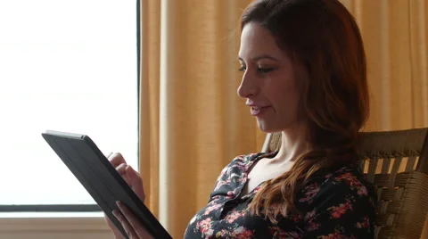 Woman browsing on tablet, side shot Stock Footage 48719926