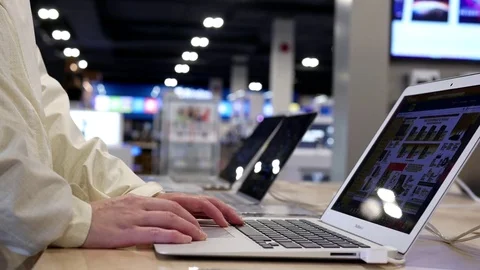 Woman browsing website on display computer inside store Stock Footage 73562612