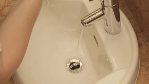 Woman brushing her teeth in front sink, practicing daily oral hygiene, prev.. Stock Footage 327208475