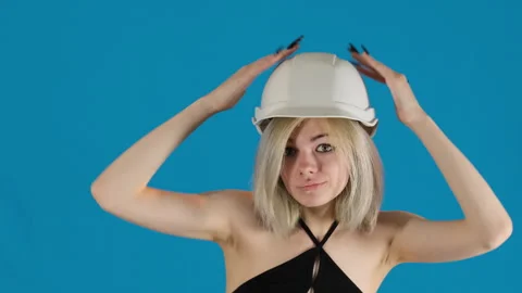 Woman builder knocks with palms on protective helmet Stock Footage 306494719
