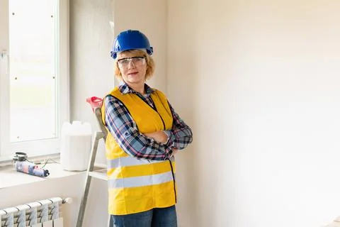 Woman Builder in the room of the house making repairs. Stock Photos