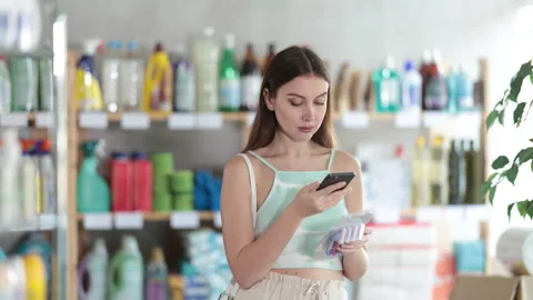 Woman buyer scans qr code on razor kit label Stock Footage 314762929