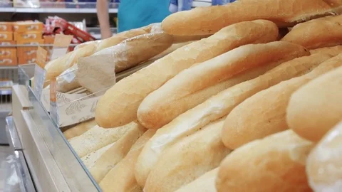 Woman buying fresh bread in a bakery products supermarket Stock Footage