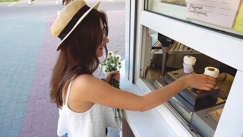 Woman buys and gets ice cream near shopwindow Video stock 90372853