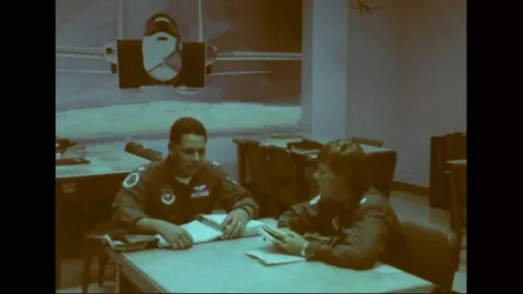 Woman cadet talks to instructor in a study hall during pilot training - 1976 Stock Footage 103749523