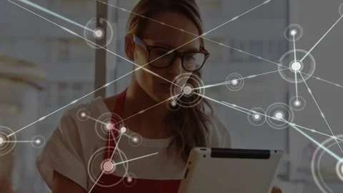 Woman in cafe holding tablet node appearing on screen starting network covering Stock Footage 333287692