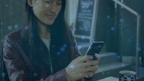 Woman at cafe tapping smartphone, testing app for technology use while hexagon Stock Footage 333720391