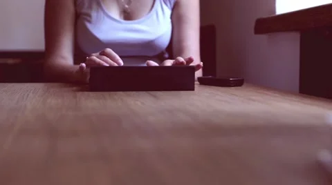A woman in a cafe using a tablet Stock Footage 58590975