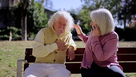 Woman calling emergencies while a man suffering a heart attack Stock-Footage 260271776
