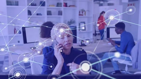 Woman calling on phone at desk, node appearing over face and network spreading, 動画素材 334179053