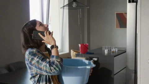 Woman Calling Plumber about Ceiling Leak Stock Footage 314122421