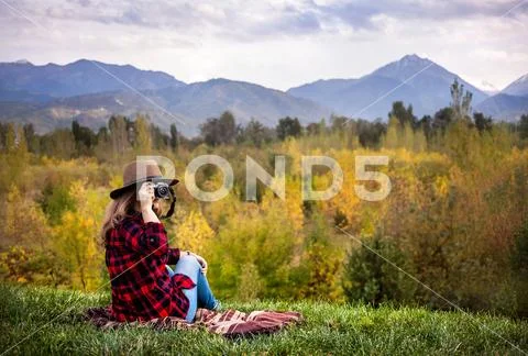 Woman with camera at autumn picnic Stock Photos