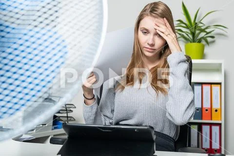 Woman can no longer stand the heat in the office Stock Photos