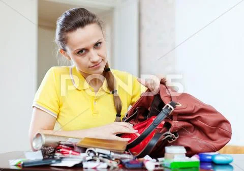 Woman can not finding anything in her handbag Stock Photos
