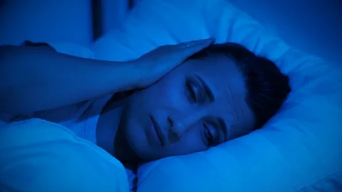 Woman cannot fall asleep due to noisy neighbors Stock Footage 117140552