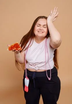 Woman can't refuse an alluring slice of pizza Stock Photos