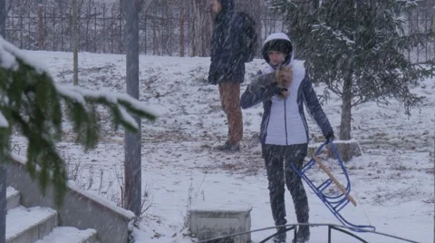 Woman is Carrying a Dog and Sleigh Bucha Ukraine Christmas Climbing up Kids 動画素材 59132367