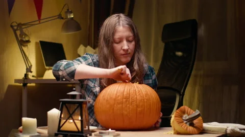 Woman carving Jack O Lantern pumpkin for Halloween Stock Footage 238081853