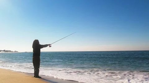 Woman casting her line while fishing on , Stock Video