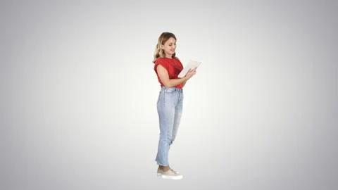 Woman in casual using tablet on gradient background. Foto stock