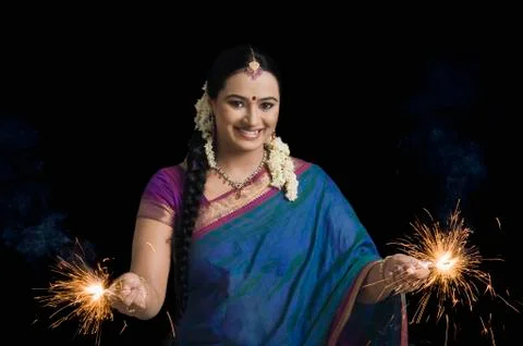 Woman celebrating Diwali festival with sparklers Stock Photos