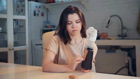 Woman changes batteries in her bionic prosthesis, close up. Stock Footage 104935463