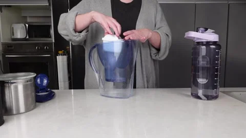 Woman changes filter in water pitcher. Stock Footage 261438531