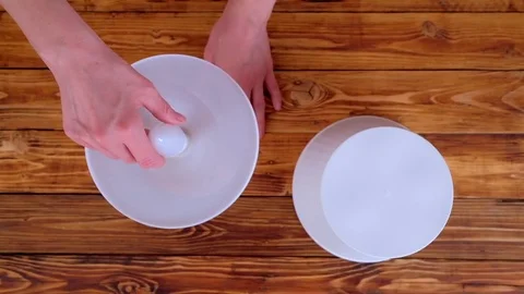 Woman changes led light bulb in white table lamp Stock Footage 84223237