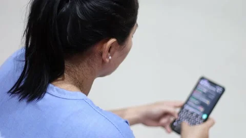 A woman is chatting using a smartphone Stock Footage 157612466