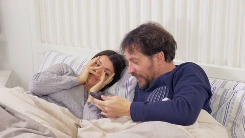 Woman cheating husband with phone in bed... | Stock Video | Pond5