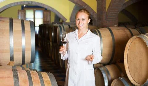 Woman checking ageing process of wine Stock Photos