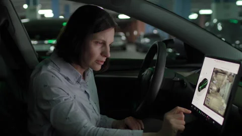 Woman Checking Car Camera on Touchscreen While Parked Stock Footage 308518633