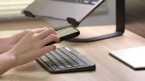 Woman checking data on smartphone at home office. Stock Footage 316657016