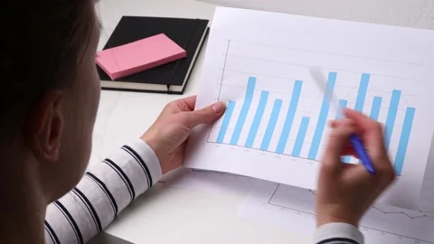 Woman checking documents with reports and statistics. Stock-Footage 243500182