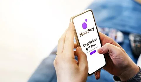 Woman checking her finances using MoonPay mobile app on her phone Foto stock