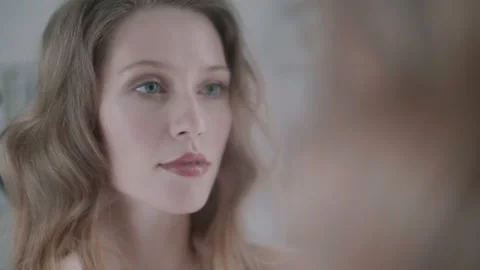 Woman checking her make up in the mirror Video stock 131067244