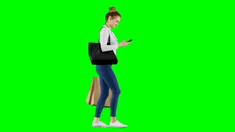 Woman Checking Her Phone While Walking Home Back From Shopping Green Screen Stock Footage 124608377