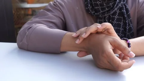 Woman checking her pulse in a close up shot, highlighting health monitoring.. Stock Footage 333154656