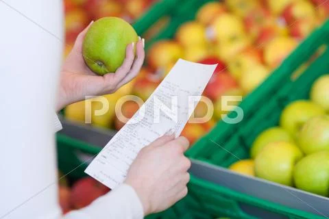 Woman checking her till slip when shopping Stock Photos