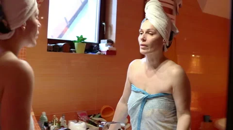 Woman is checking himself in a mirror  Stock Footage 61926005