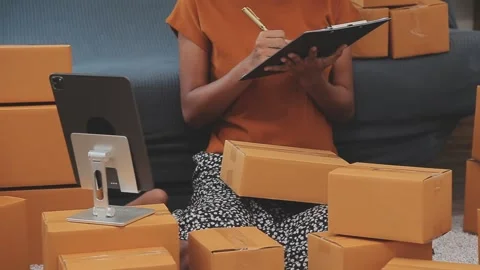 Woman checking inventory boxes in small business at home office Stock Footage 325419858