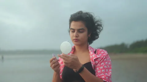 Woman Checking Makeup with Mirror on Beach Stock Footage 329502911