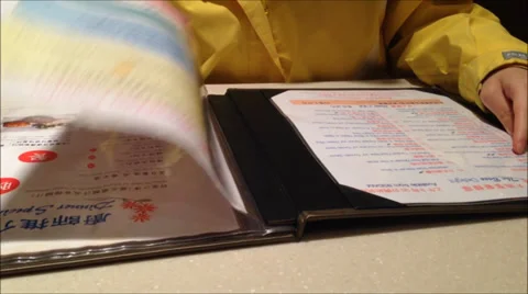 Woman checking the menu inside restaurant Stock Footage 37759437