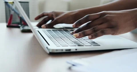 Woman checking phone while typing on laptop Stockbeeldmateriaal 155113189