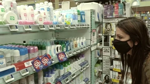 Woman Checking Products at Shop While Wearing a Mask During Covid-19 Pandemic Stock Footage 140926119