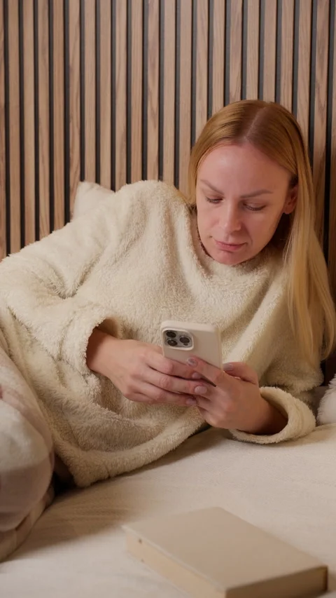 Woman checking smartphone during quiet evening at home. Evening routine and.. Stock Footage 327811896