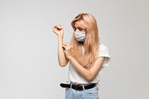 Woman Checking Temperature While Wearing Mask Stock Photos