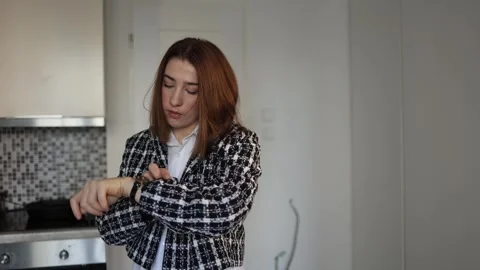 Woman checking time on watch while getting ready at home Video stock 327217042