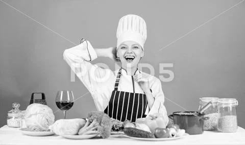 Woman chef cooking healthy food. Gourmet main dish recipes. Girl in hat and Stock Photos